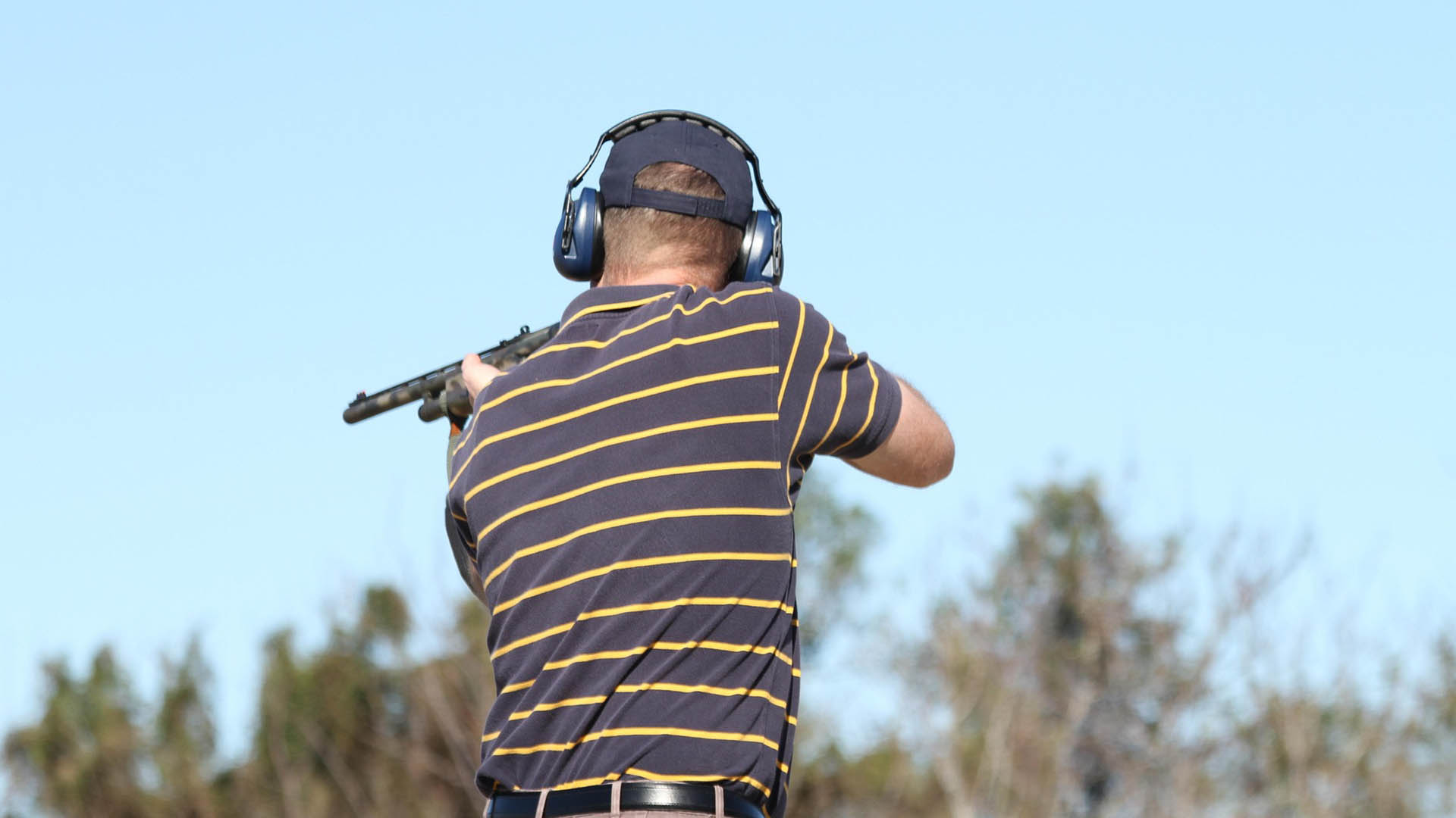 Man shooting gun outside